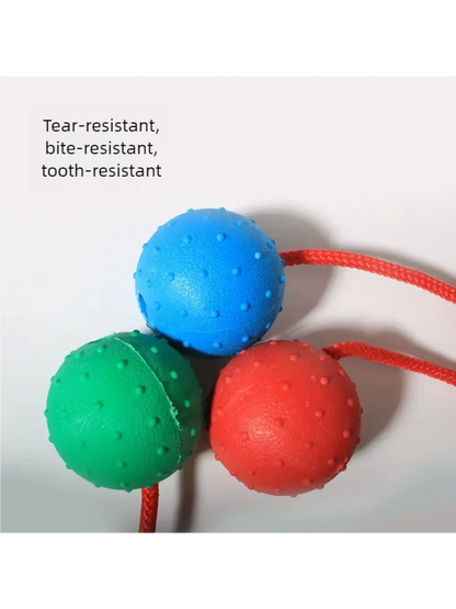 Durable textured dog chew balls in blue, green, and red with rope, tear and bite resistant.