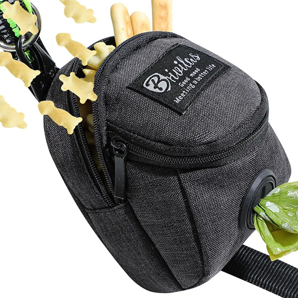 Black dog treat pouch with zipper, clip, bone-shaped treats, and waste bag dispenser