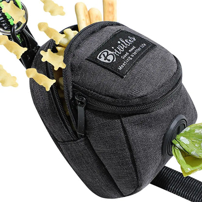 Black dog treat pouch with zipper, clip, bone-shaped treats, and waste bag dispenser