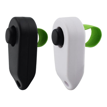 Black and white dog training clickers with green wrist straps