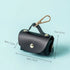 Black leather dog waste bag holder pouch with gold clasp and size dimensions on blue background