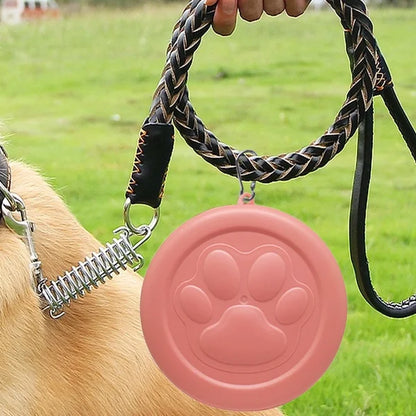 portable dog travel bowl hanging on a leash beside a dog, 2-in-1 pet food and water dish with treat compartment