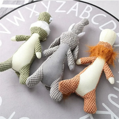 Plush textured dog toys in animal shapes, displayed on a round mat with alphabet letters