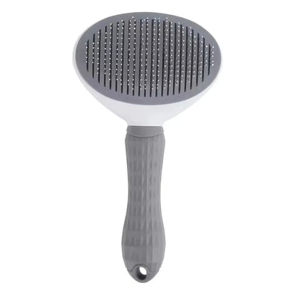 Gray dog grooming brush with ergonomic handle and fine bristles on white background