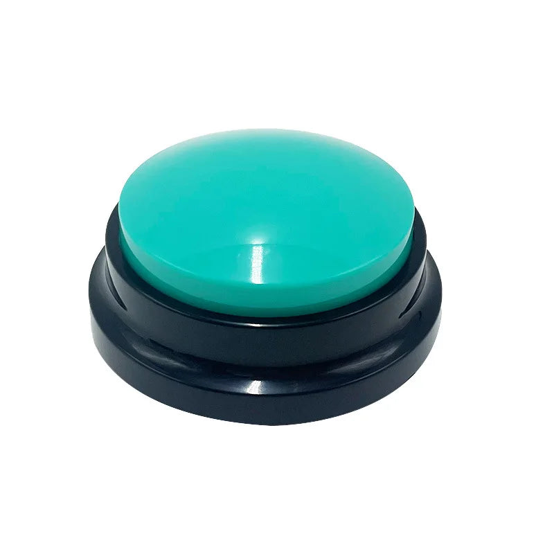 Dog training button with teal top and black base on white background