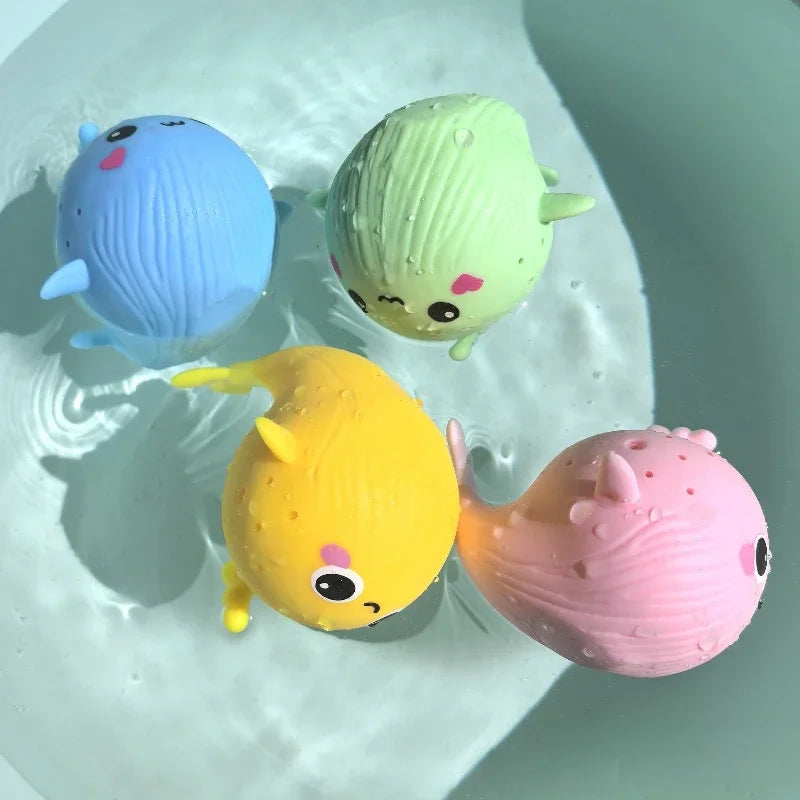 baby whale bath toys floating in water, colorful squishy whale squeeze toys for children, summer swimming play