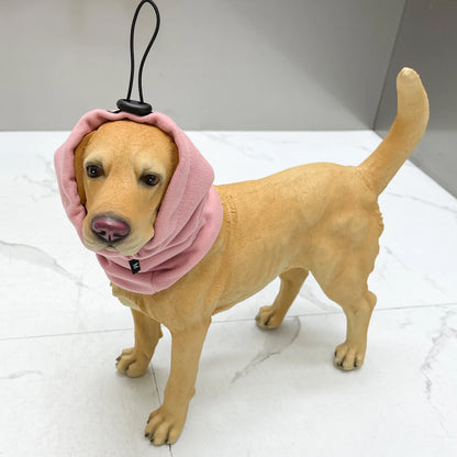 Dog mannequin wearing pink adjustable dog ear cover for grooming on white background