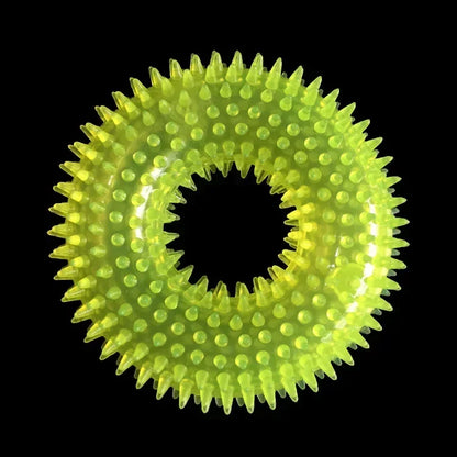 Yellow spiky rubber dog chew ring toy on black background