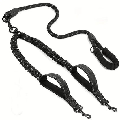 Black double dog leash with padded handle and reflective stitching, designed for walking two dogs.