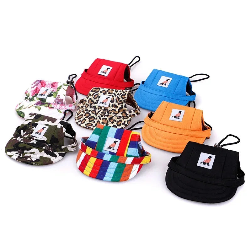 Assorted colorful dog hats in various patterns including floral, camo, leopard, stripes, and solid colors.
