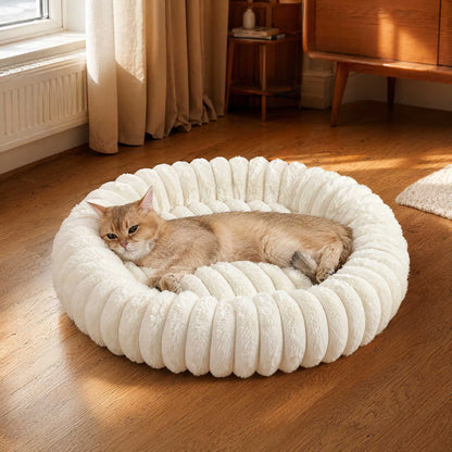 Plush donut cat bed with a cozy white round design for a small cat resting comfortably indoors