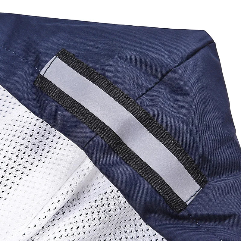 Closeup of a navy and white dog vest with reflective safety strip and breathable mesh fabric