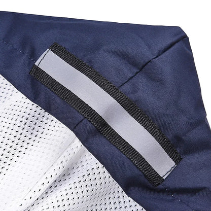 Closeup of a navy and white dog vest with reflective safety strip and breathable mesh fabric