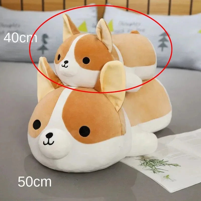 Two plush corgi dog toys in sizes 40cm and 50cm on a bed