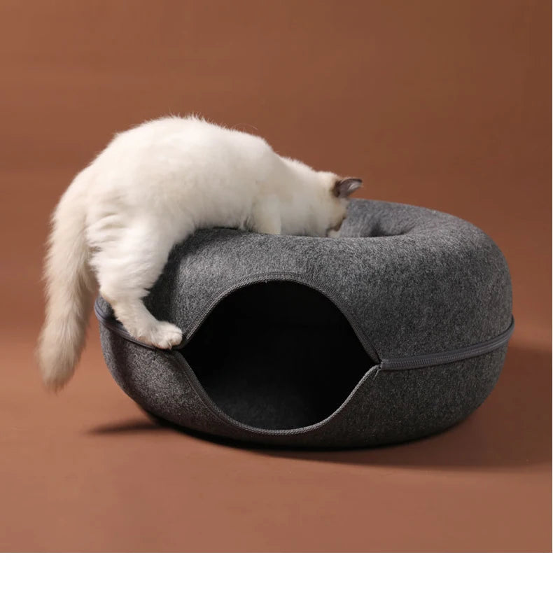 White cat resting on a round cat tunnel bed, cozy donut-style pet nest for sleeping, hiding, and play