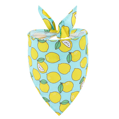 Dog bandana with yellow lemon print on blue fabric, trendy pet accessory.