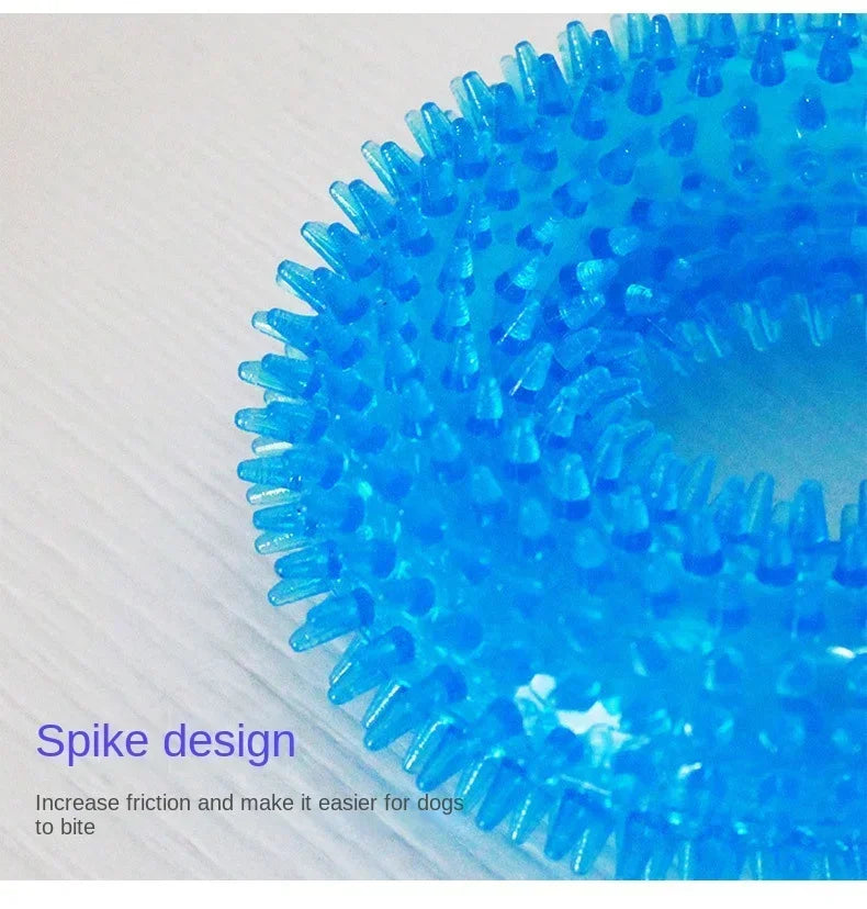 Blue spiked rubber dog chew toy with textured surface on a light background