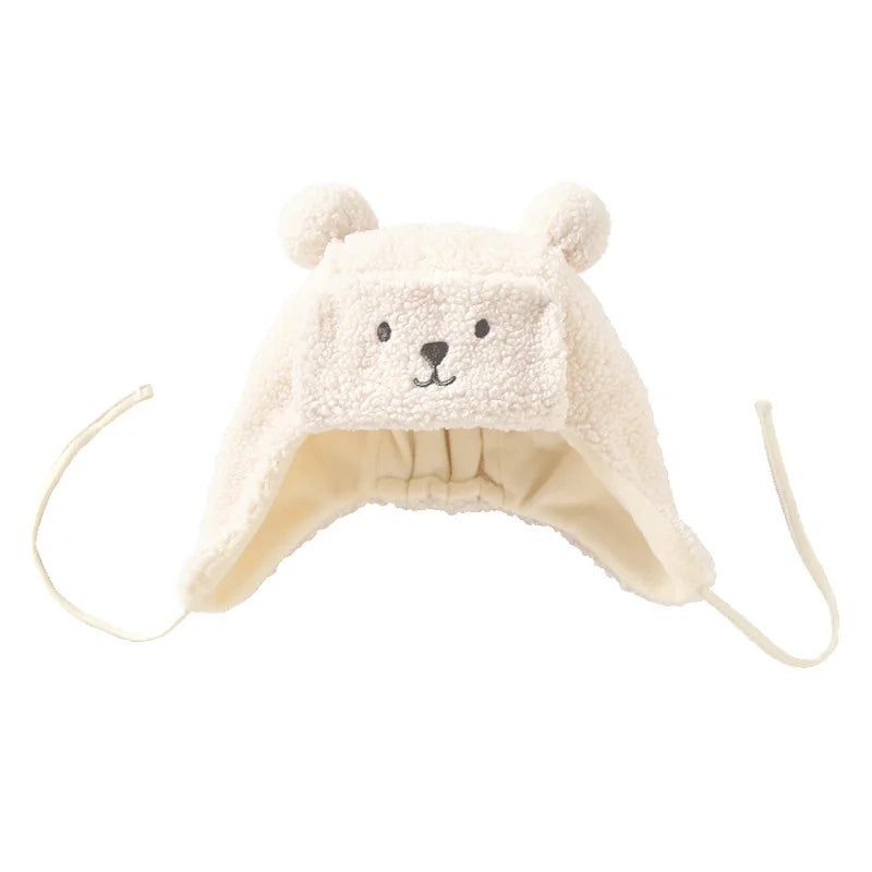 Cream sherpa dog hat with bear face embroidery and ear flaps, adjustable ties