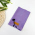 Purple fleece dog apparel accessory with adjustable cord on white background