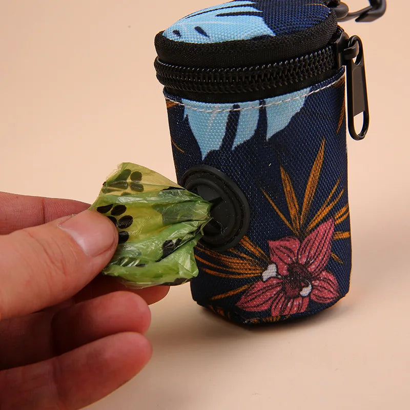 Floral dog poop bag dispenser pouch with hand pulling green waste bag