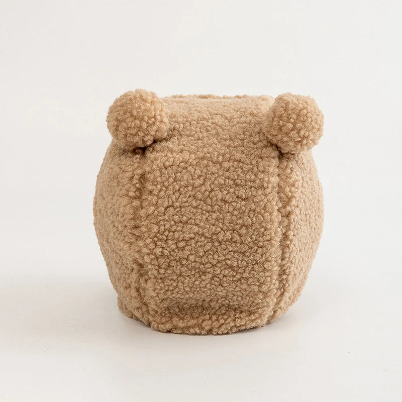 Plush tan dog toy with round ears and soft textured fabric on a plain white background