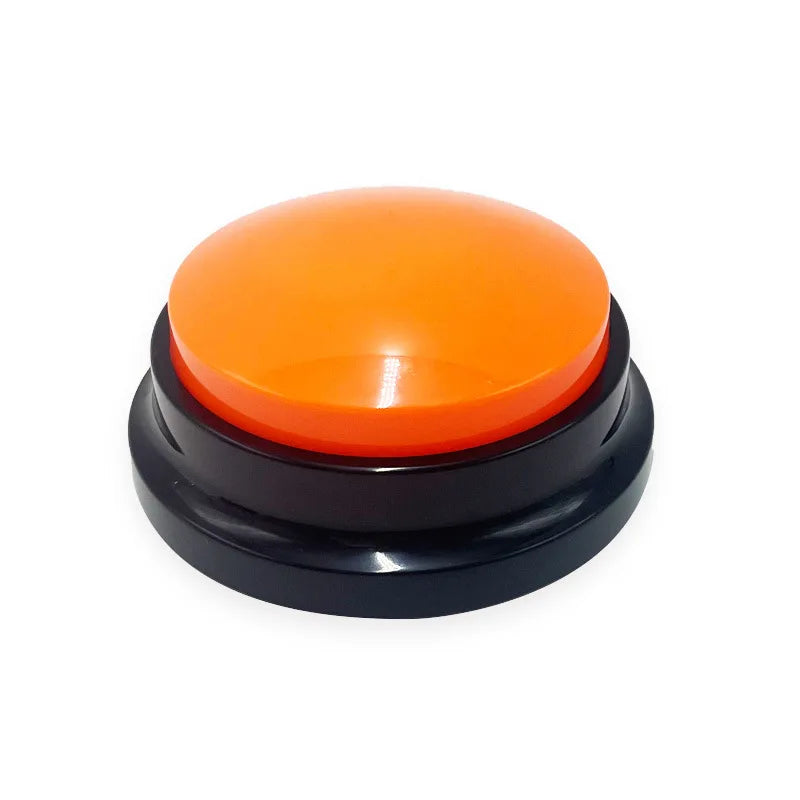 Orange dog training button toy with black base on white background