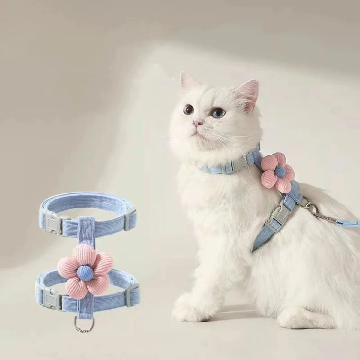 White cat wearing an adjustable small dog harness leash set with flower detail, breathable pet harness for walking