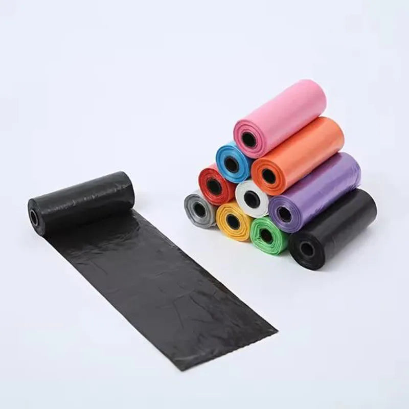 Colorful dog waste bag rolls with one black bag unrolled on white background
