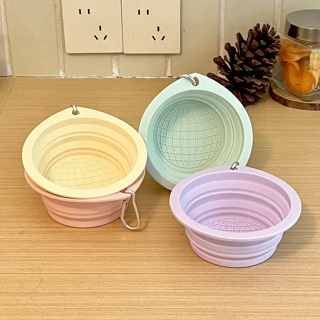 Collapsible travel dog bowl in pastel colors, foldable silicone pet bowl for portable travel, water and food feeding.