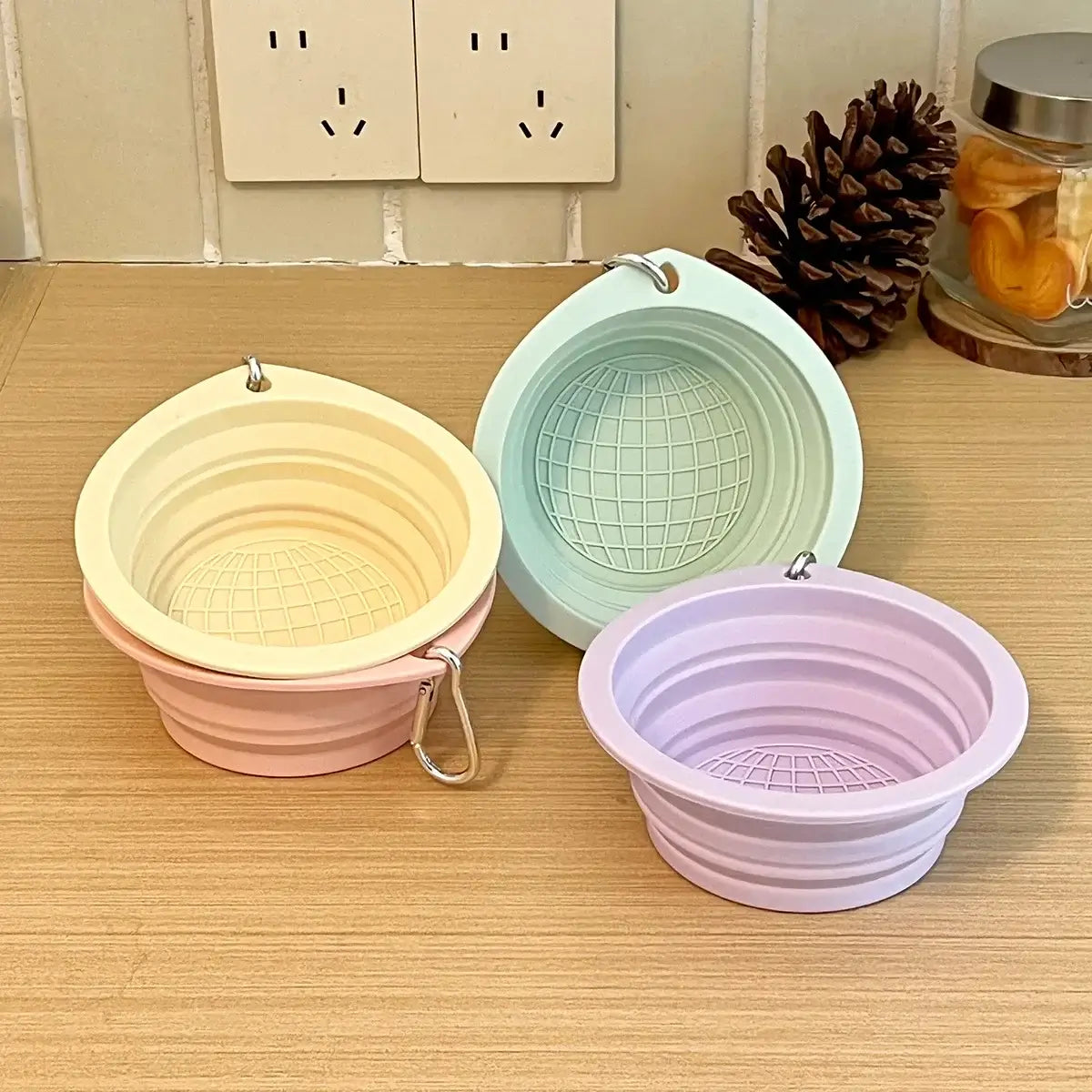 Collapsible travel dog bowl in pastel colors, foldable silicone pet bowl for portable travel, water and food feeding.