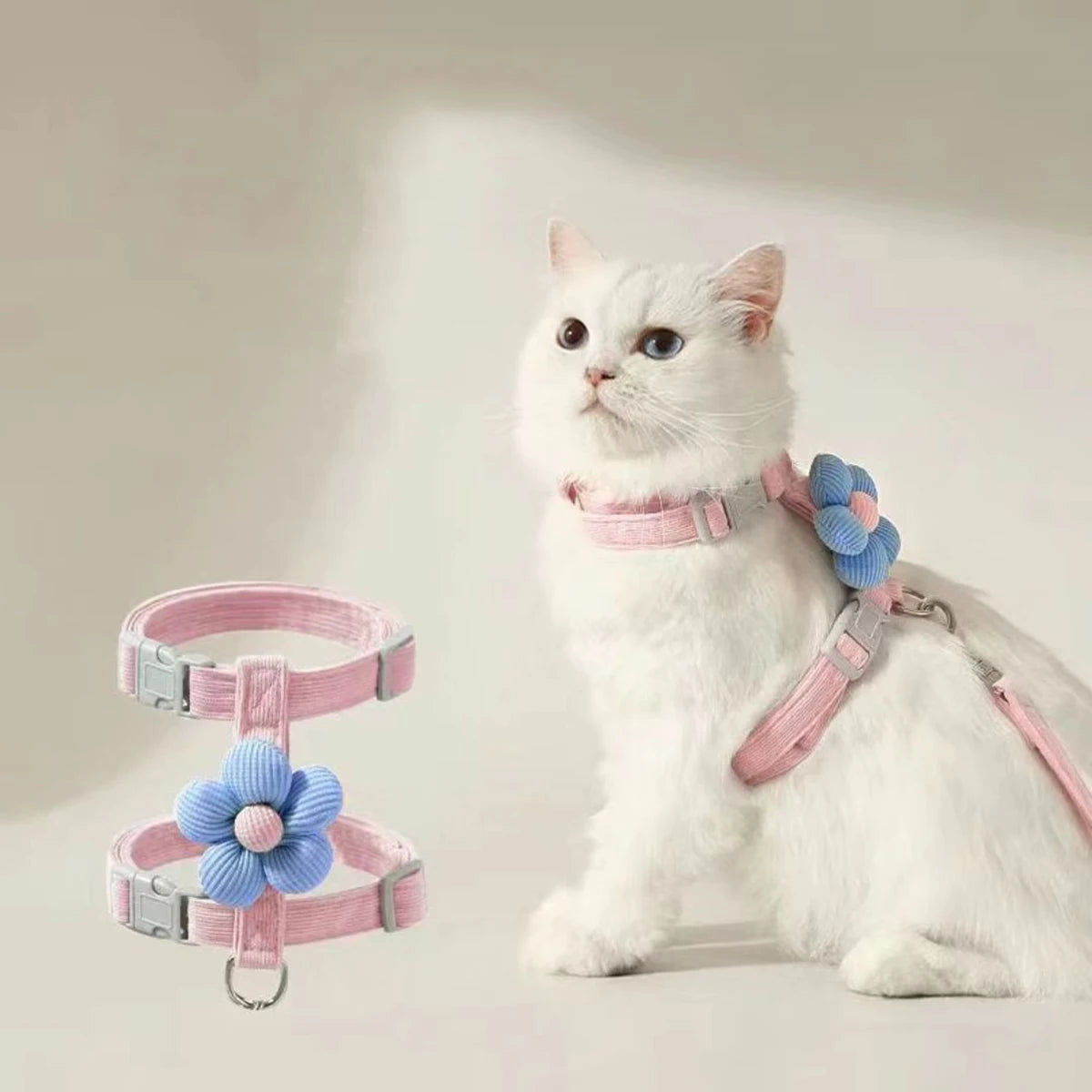 White cat wearing pink adjustable small dog harness leash set with flower detail, pet walking accessory