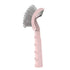 Pink ergonomic dog grooming brush with curved metal bristles for detangling fur