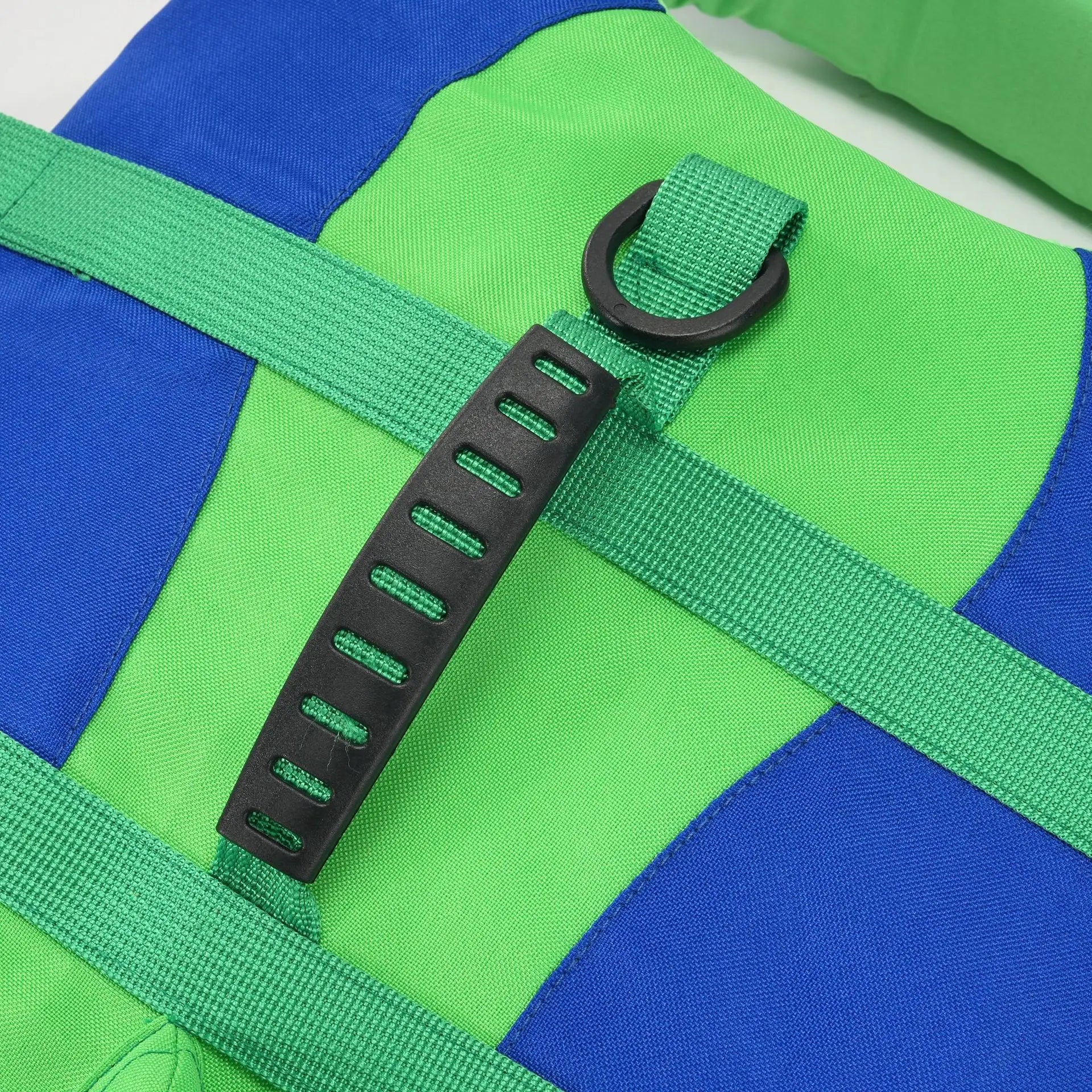 Dog life jacket with reinforced handle, reflective strap, and adjustable harness for safe swimming in green and blue