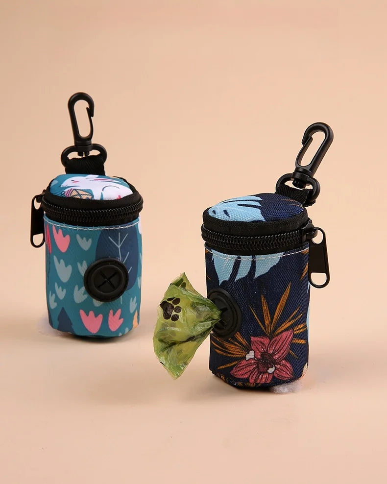 Two floral print dog waste bag holders with clips, one dispensing a green bag