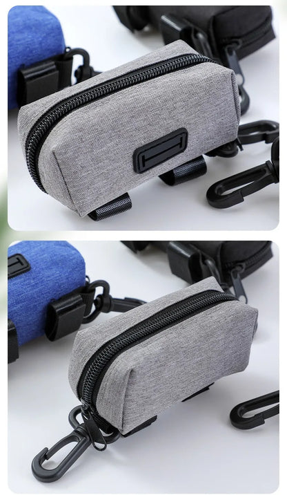 Gray fabric dog waste bag holder with zipper, clip, and loop for leashes