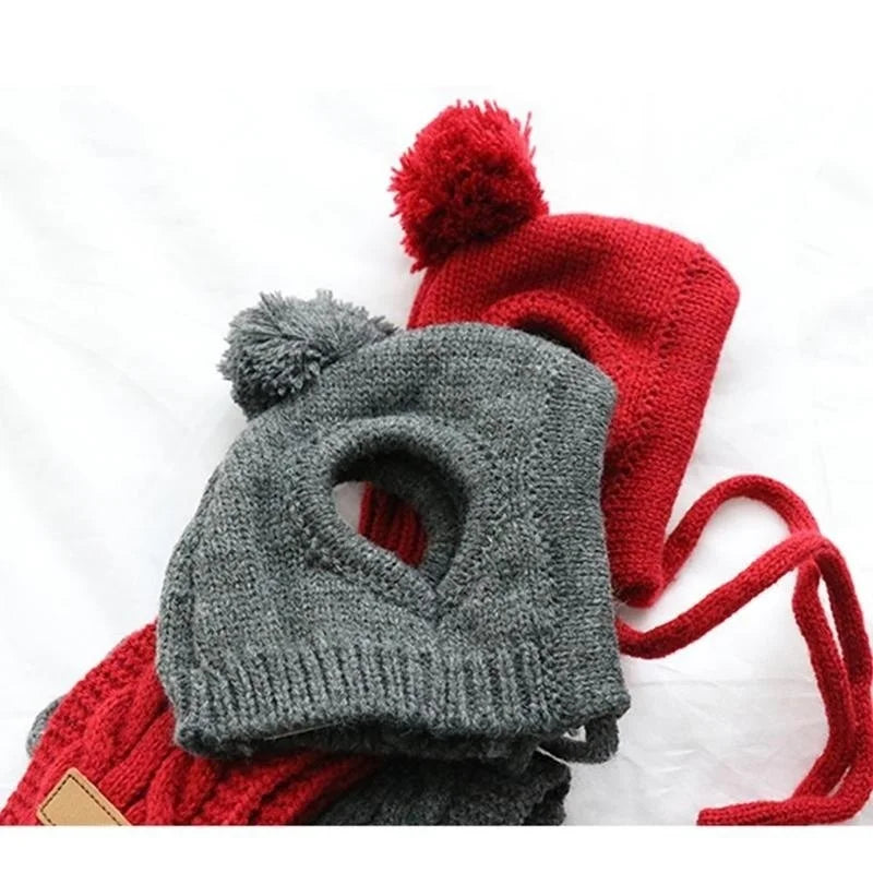 Knitted dog hats in grey and red with pom-poms and ear holes, cozy pet winter accessories