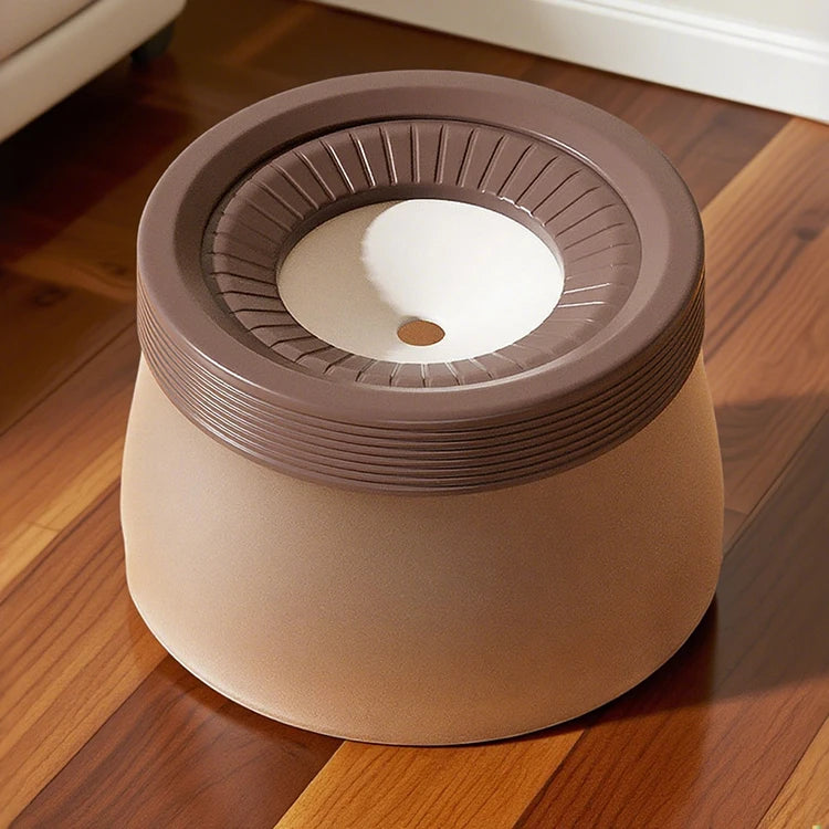 Brown indoor dog bed shaped like a bowl, placed on hardwood floor.