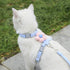 Blue adjustable small dog harness leash set on white cat, breathable pet strap for walking, cute flower detail