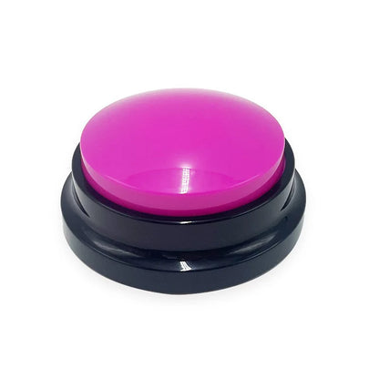 Pink dog training button toy with black base on white background