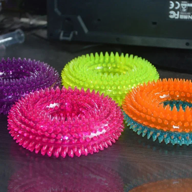 Colorful spiky rubber dog chew rings on a table, pet toy for dental health and play