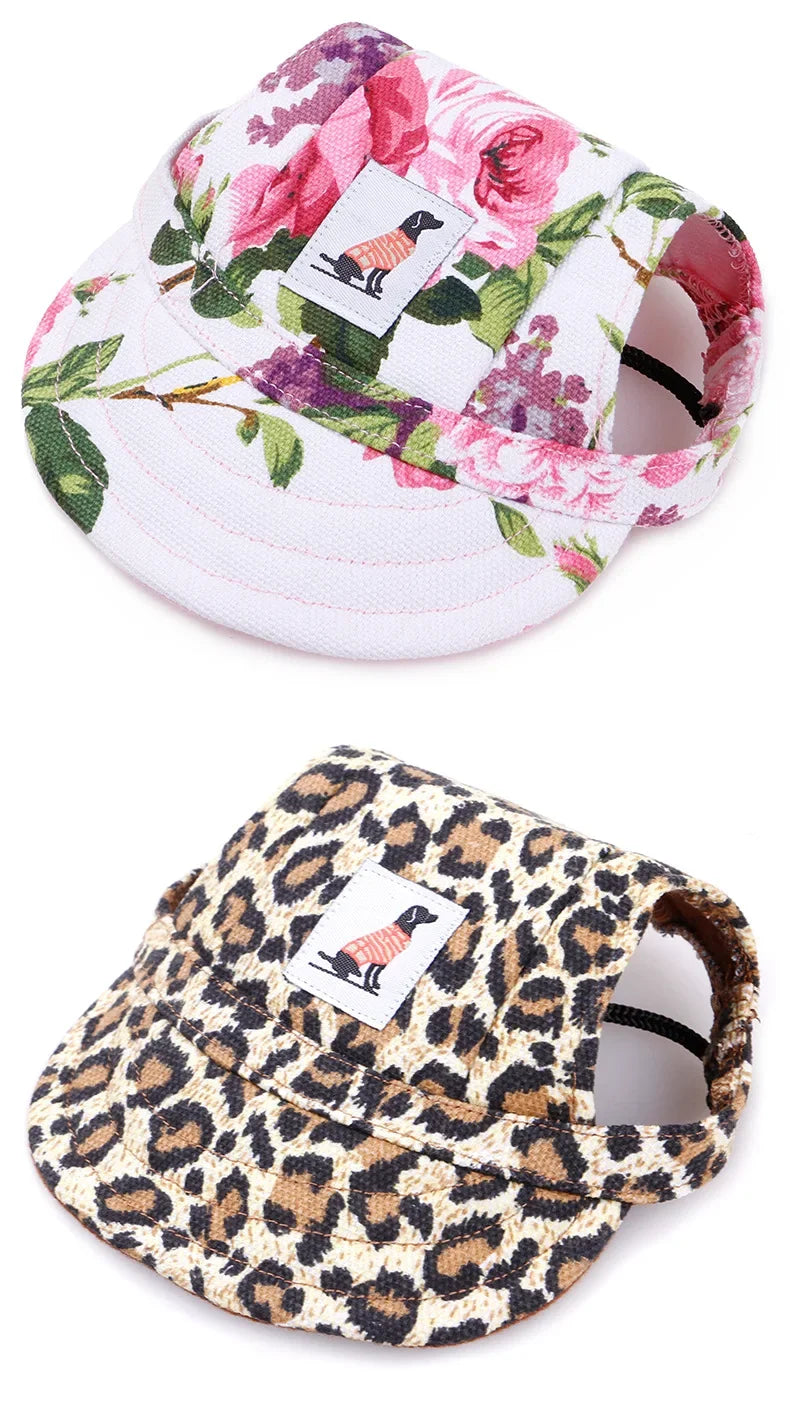 Two dog hats, one with pink floral print and one with leopard print, dog patch on front