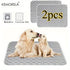 Two golden retrievers on gray washable dog training pads, pack of 2