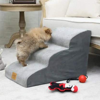 A small dog climbing on anti-slip dog stairs for small dogs in a cozy living room setting.