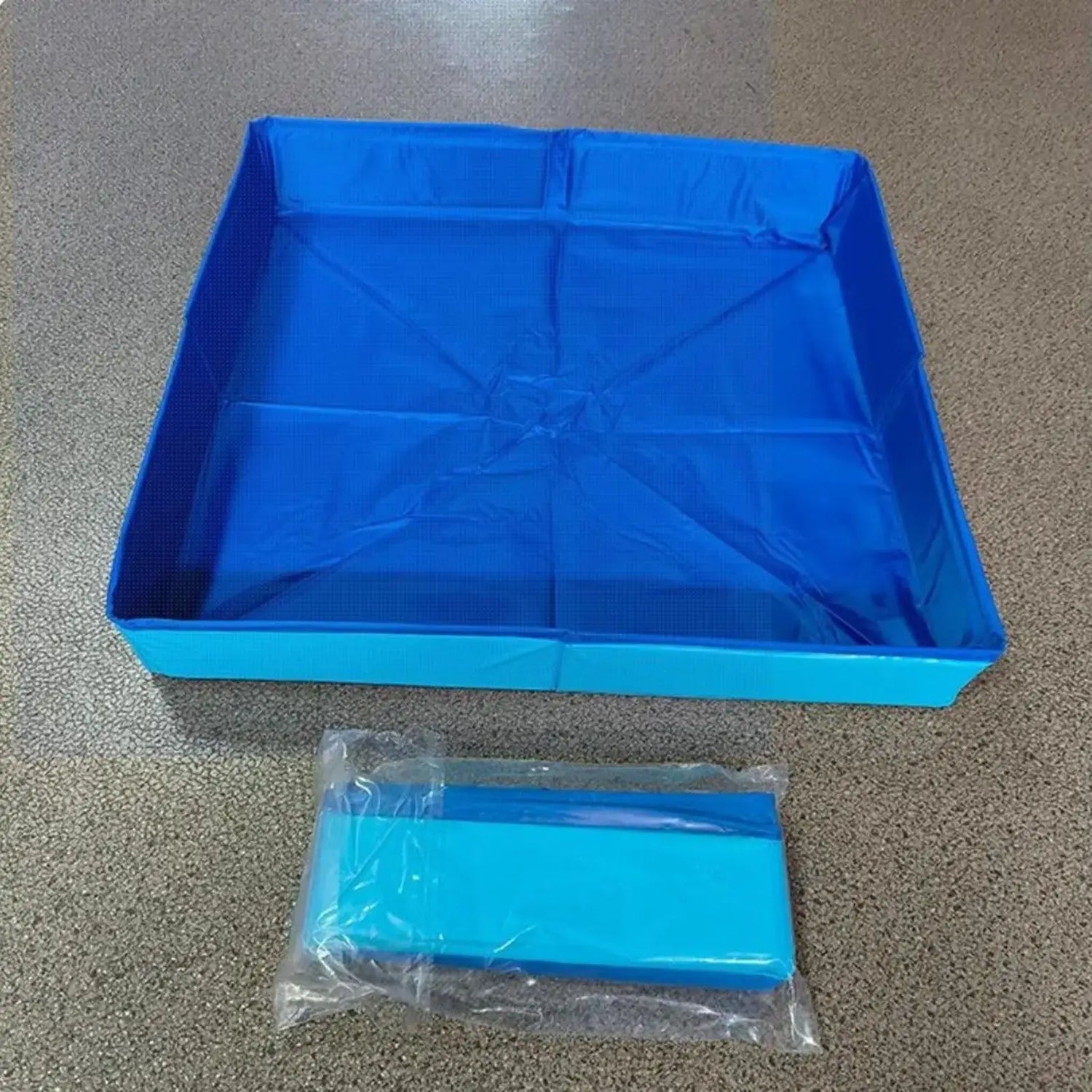 Dog kiddie folding pool in bright blue color, foldable design for easy storage and transport.