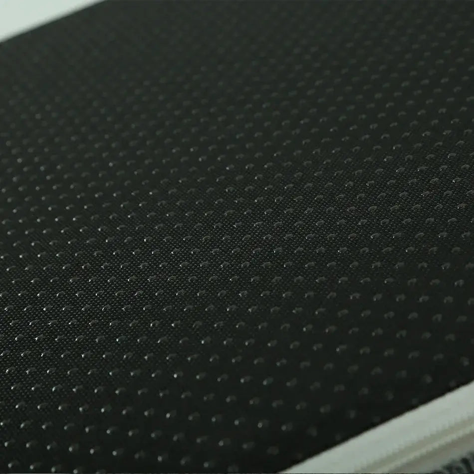 Close-up of a textured black surface with small dot patterns, showcasing durability and style.