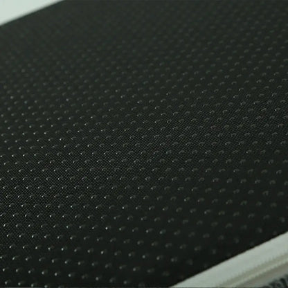 Close-up of a textured black surface with small dot patterns, showcasing durability and style.