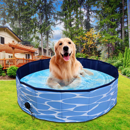 Golden retriever relaxing in a foldable dog swimming pool outdoors with blue water pattern.