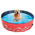 Golden retriever enjoying a bath in a foldable dog swimming pool with red sea wave design.