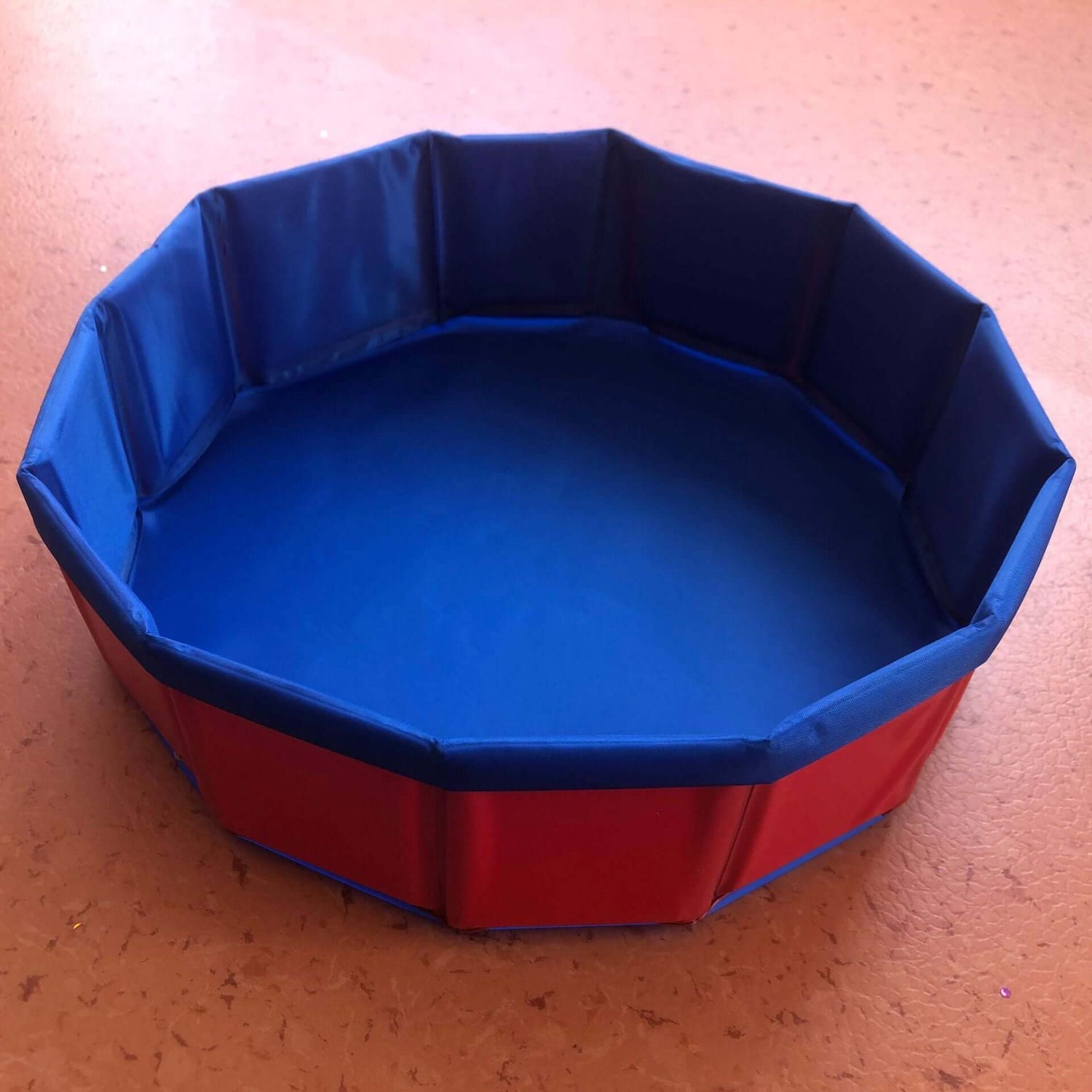 Foldable dog swimming pool in vibrant red and blue colors, perfect for pets and versatile use.