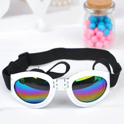 White dog sunglasses with rainbow lenses and adjustable black strap, foldable windproof sun protection for pets